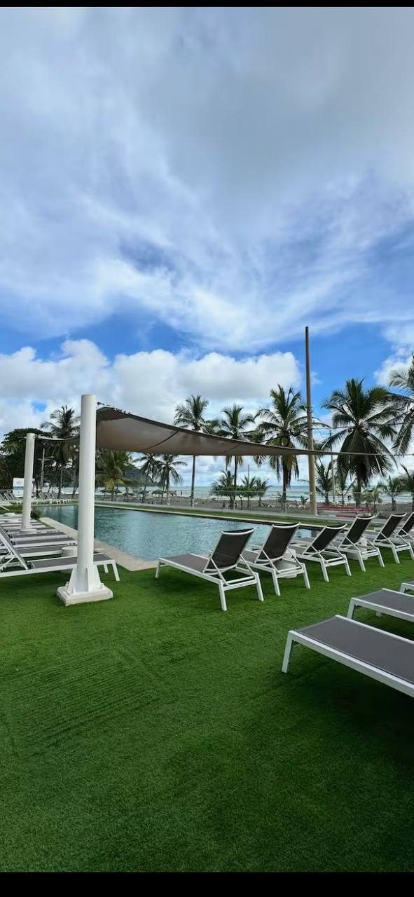Sun deck with loungers next to the pool