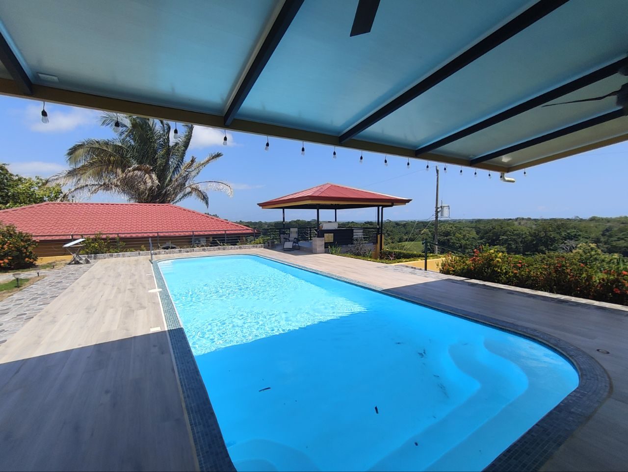 Covered pool terrace with hills view